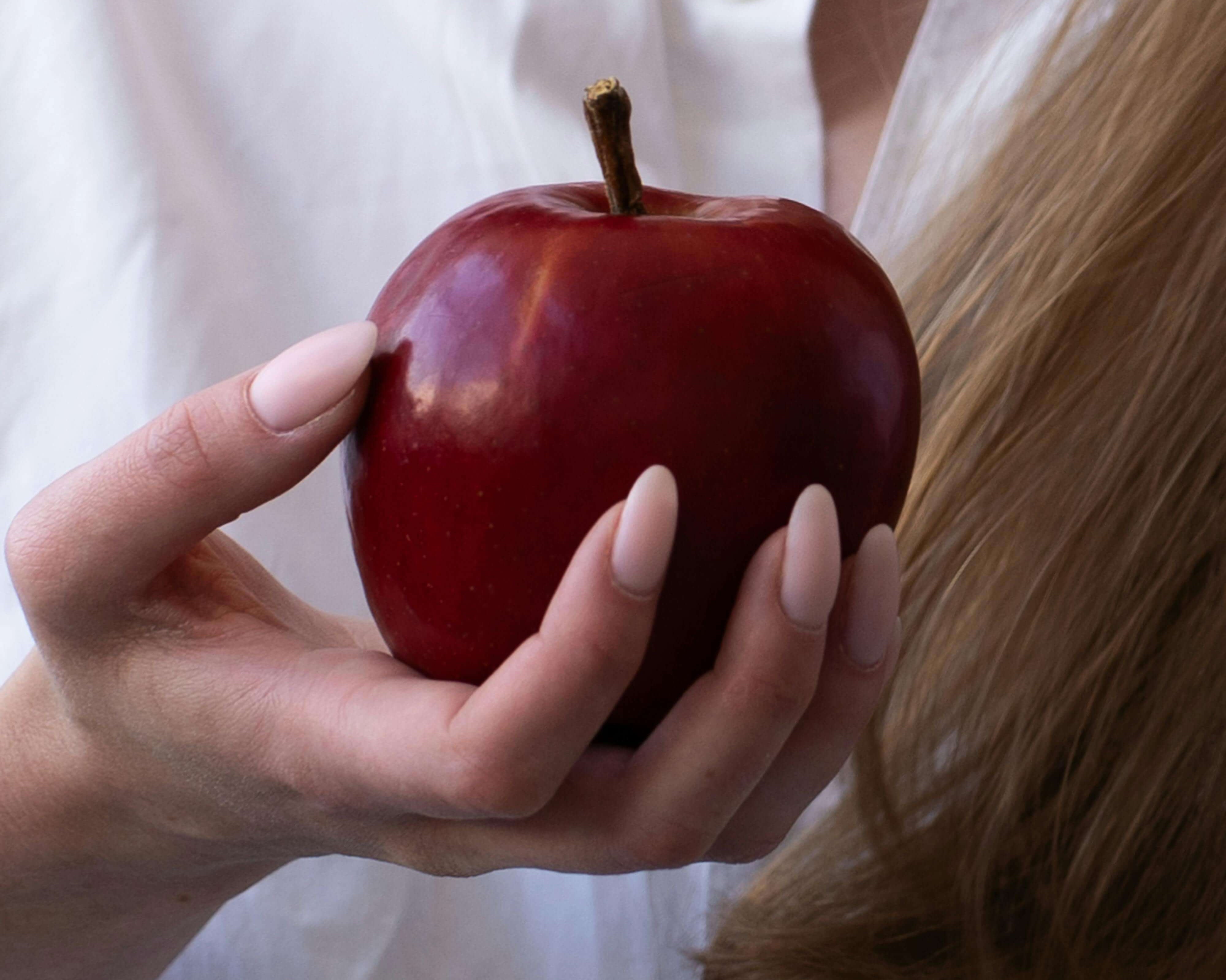 woman holding apple