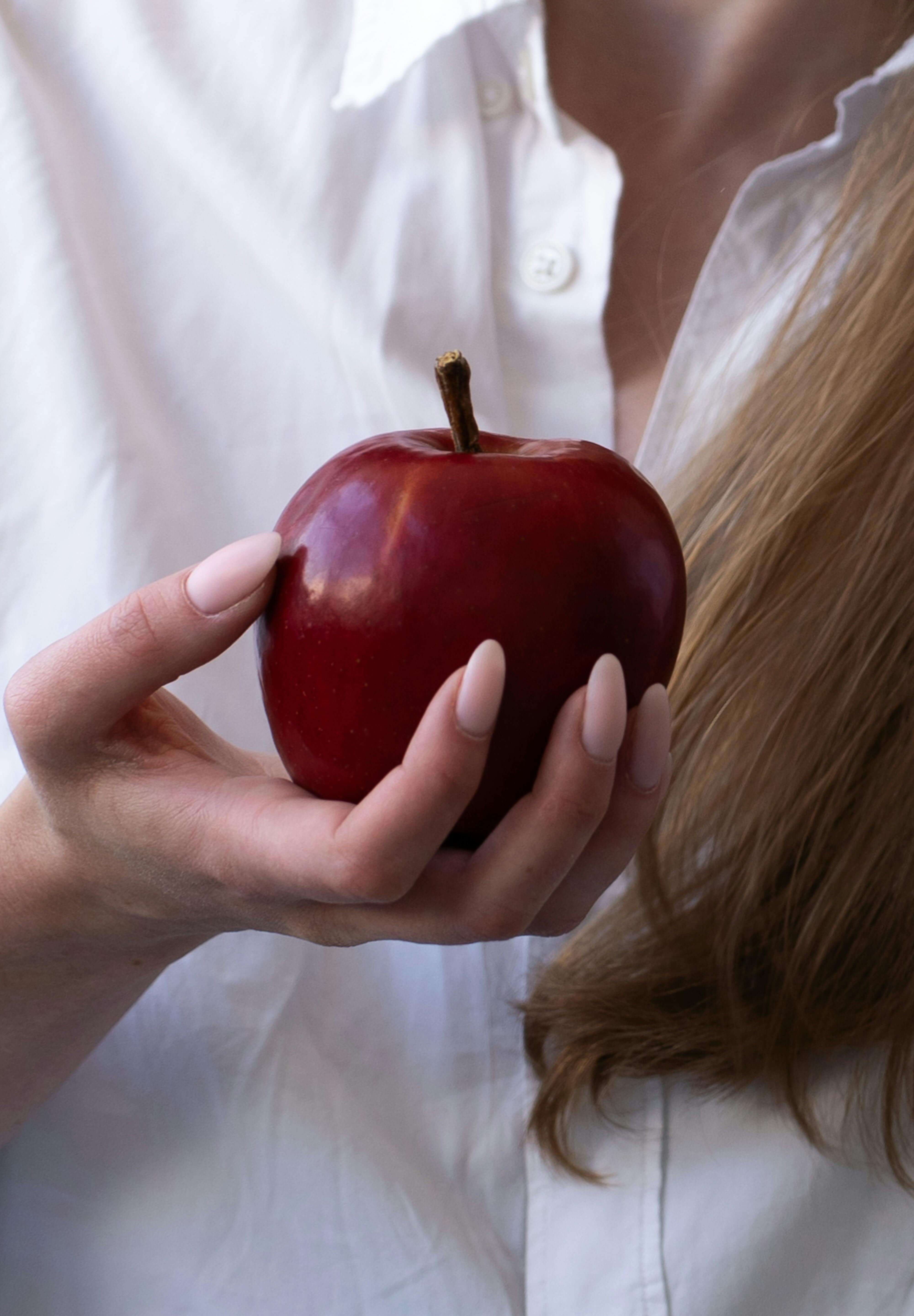 woman holding apple