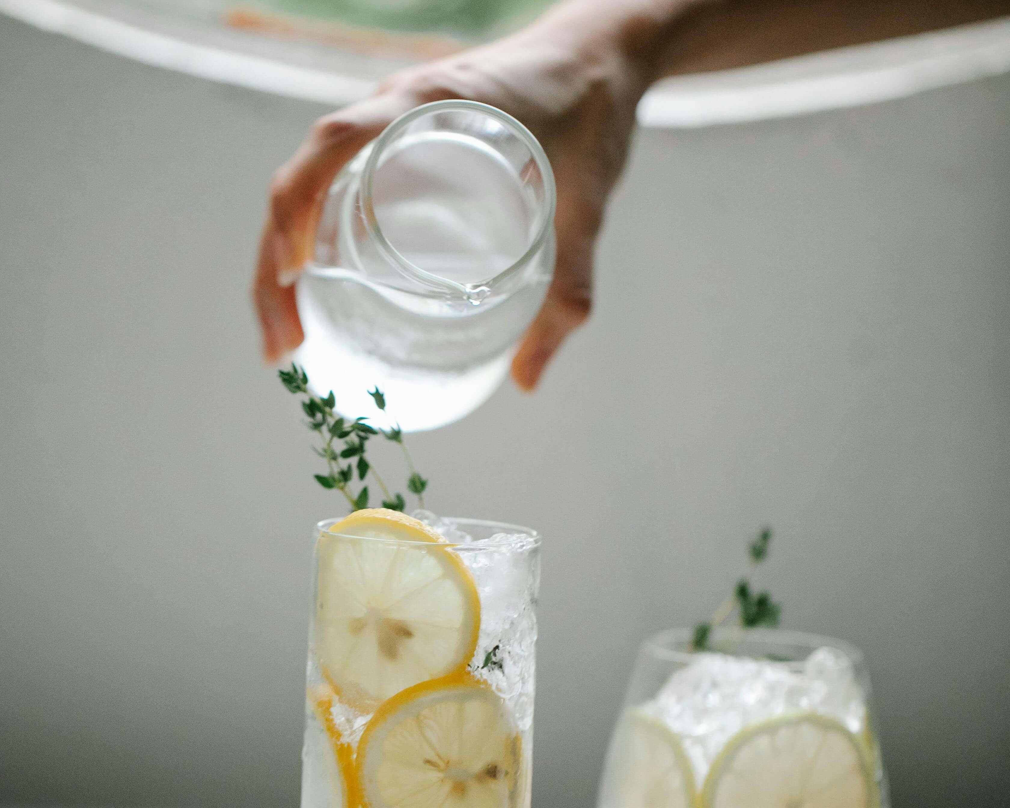 person pouring lemon water