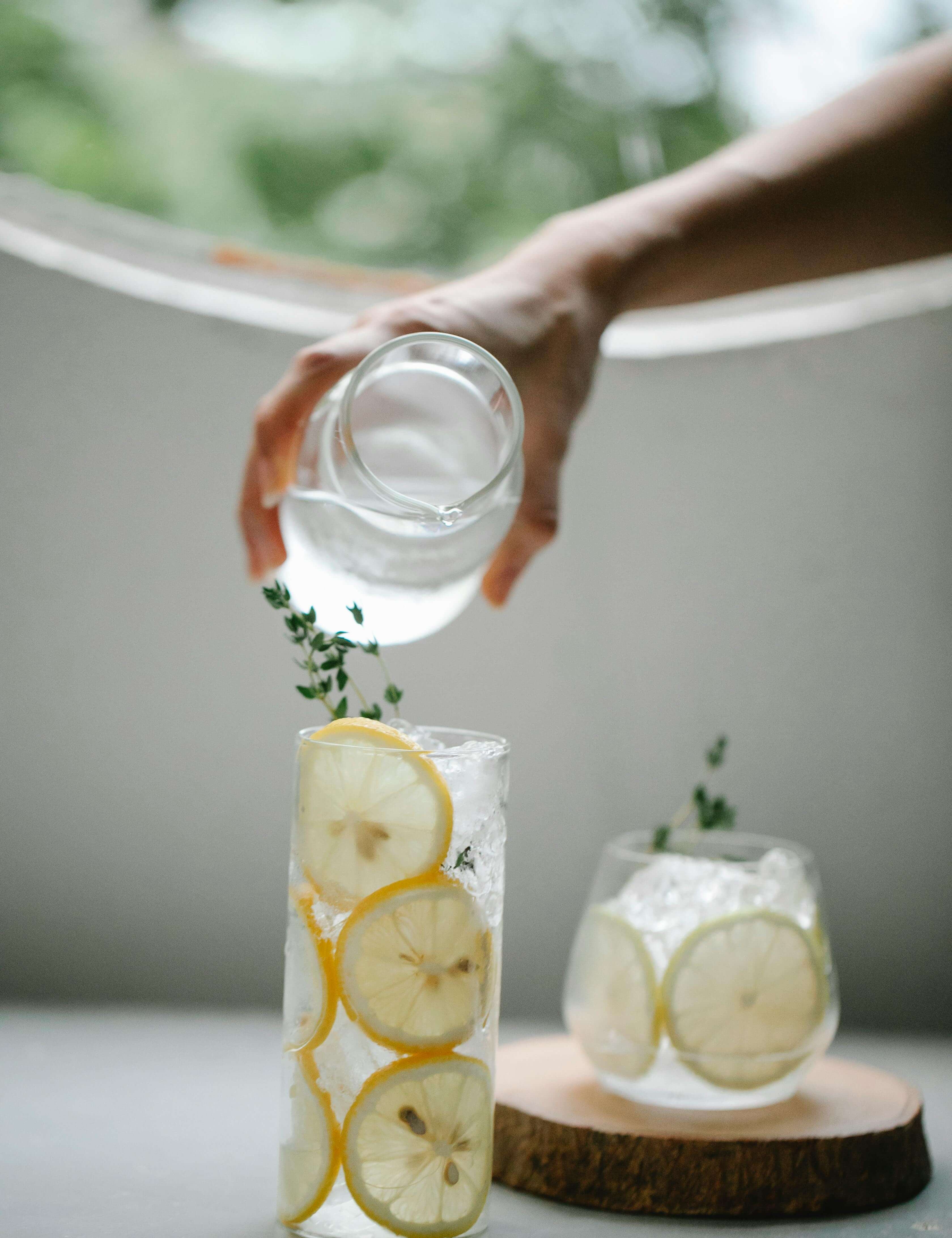 person pouring lemon water