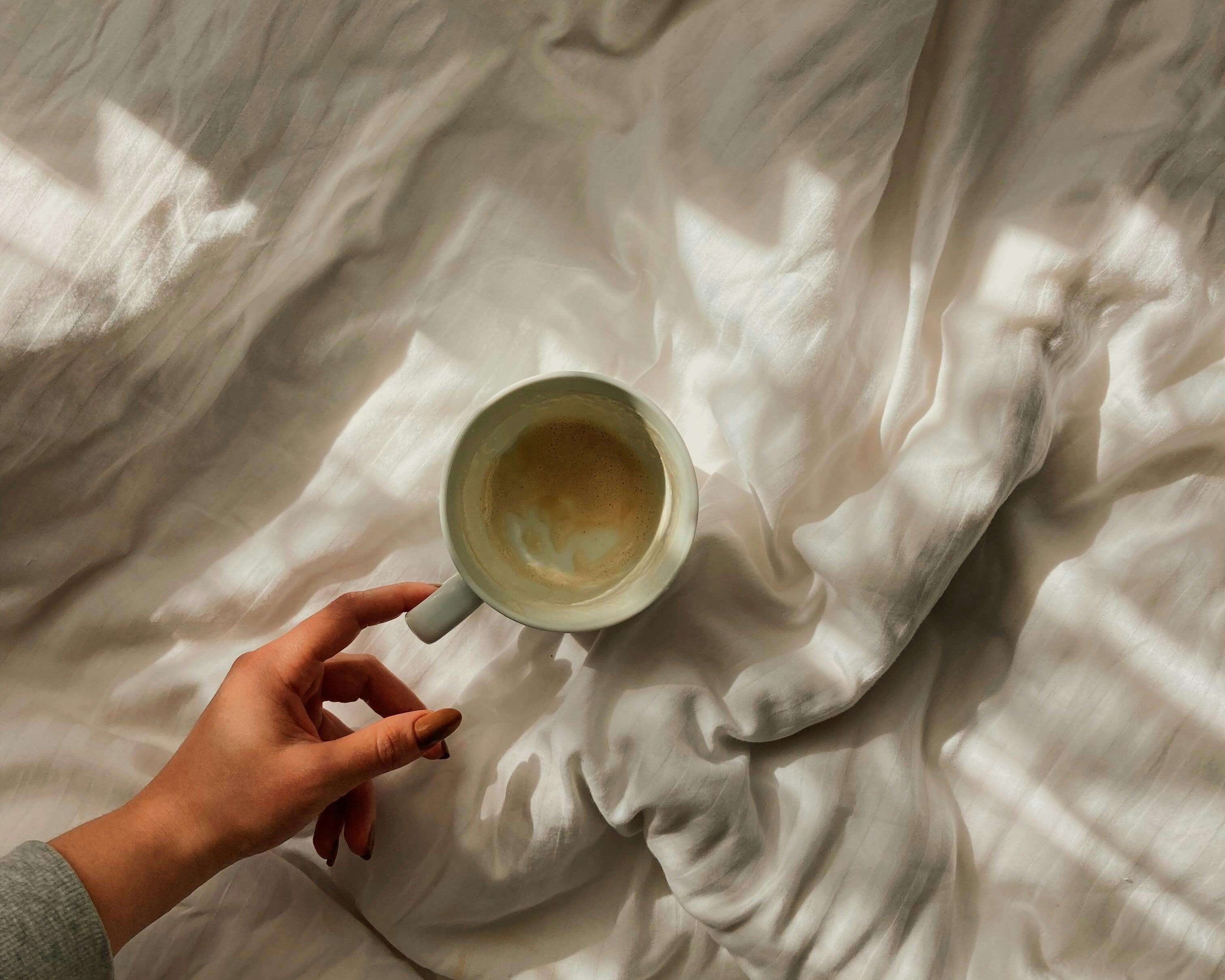 Cosy coffee cup in bed