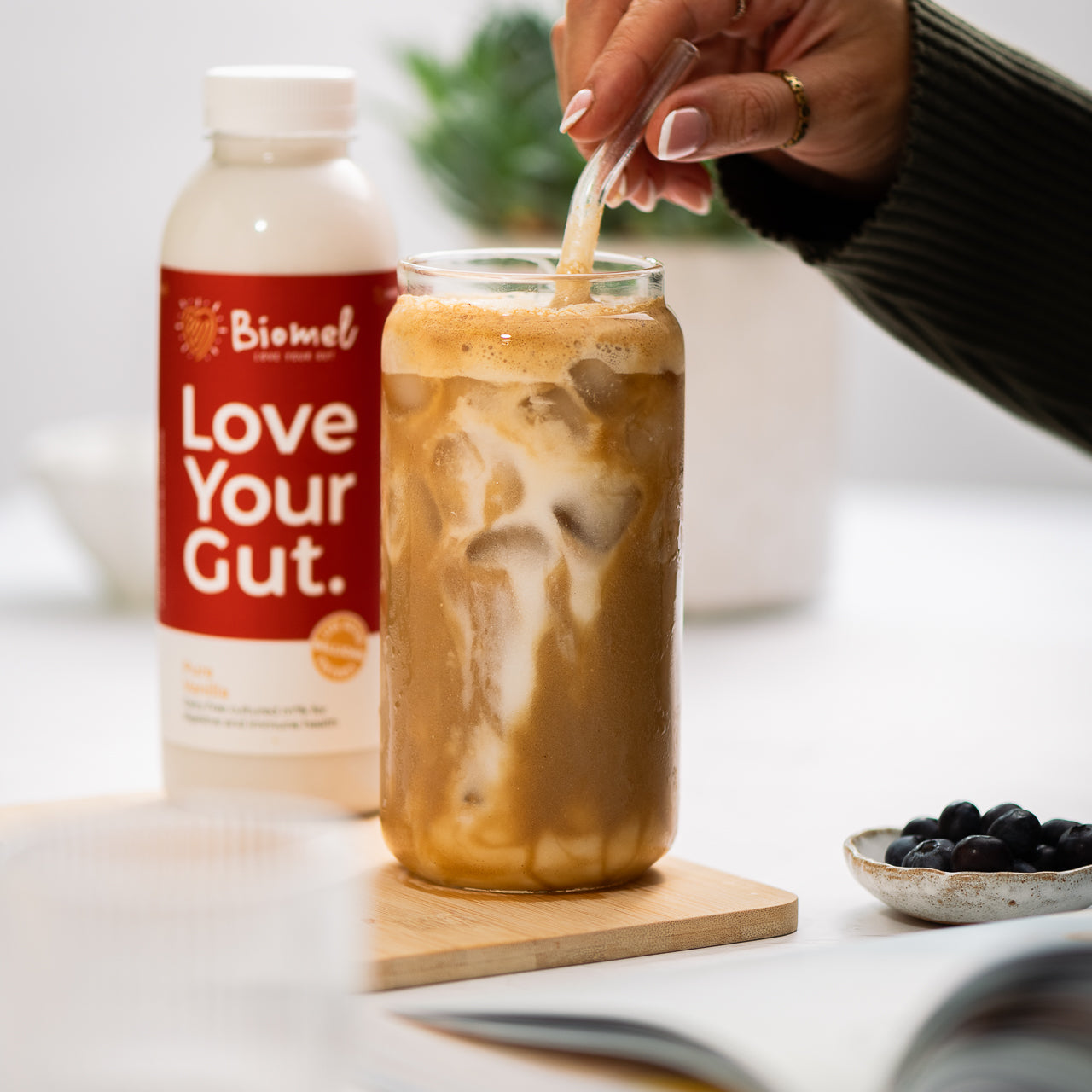 A biomel drink being enjoyed with love your gut slogan on bottle